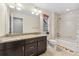 Bathroom with double sinks, granite countertop, and bathtub at 7932 E 49Th Pl, Denver, CO 80238