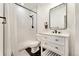 Modern bathroom with white vanity and walk-in shower at 7932 E 49Th Pl, Denver, CO 80238