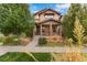 Beautiful two-story home with a landscaped front yard and porch at 7932 E 49Th Pl, Denver, CO 80238