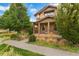 Two-story home with front porch and landscaping at 7932 E 49Th Pl, Denver, CO 80238