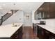 Modern kitchen with dark cabinetry and stainless steel appliances at 7932 E 49Th Pl, Denver, CO 80238