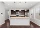 Modern kitchen with island and stainless steel appliances at 7932 E 49Th Pl, Denver, CO 80238