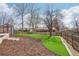 Backyard featuring a lush lawn, small storage shed, and beautiful mature trees at 2085 S Deframe St, Lakewood, CO 80228