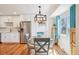 Dining area with modern light fixture and stainless steel refrigerator at 2085 S Deframe St, Lakewood, CO 80228