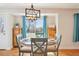Dining area with wooden furniture set, modern light fixture, and natural light at 2085 S Deframe St, Lakewood, CO 80228