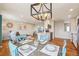 Open concept living space with dining area featuring stylish light fixture and adjacent kitchen at 2085 S Deframe St, Lakewood, CO 80228