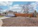 Front yard featuring a manicured lawn and mulch landscaping at 2085 S Deframe St, Lakewood, CO 80228