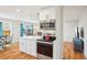 Open kitchen with modern appliances, quartz countertops, and adjacent living area at 2085 S Deframe St, Lakewood, CO 80228