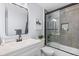 Modern bathroom with white vanity, walk-in shower, and bathtub at 1109 Ash Ct, Fort Lupton, CO 80621