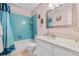 Bathroom with blue tiled shower and a vanity with sink at 7110 S Gaylord St # O7, Centennial, CO 80122