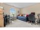 Bedroom featuring a window, a daybed with pillows, a chair, and a computer desk at 7110 S Gaylord St # O7, Centennial, CO 80122