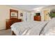 Bedroom with white walls, wood furniture, and a view into the en suite bathroom at 7110 S Gaylord St # O7, Centennial, CO 80122