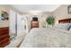 Spacious bedroom featuring wood furniture and a view into an ensuite bathroom and closet at 7110 S Gaylord St # O7, Centennial, CO 80122