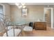 Elegant dining room area featuring a glass table and chandelier lighting at 7110 S Gaylord St # O7, Centennial, CO 80122