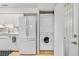 Functional kitchen area with laundry, stainless steel refrigerator at 7110 S Gaylord St # O7, Centennial, CO 80122