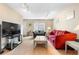 Bright living room with light wood floors, comfortable seating, and a large window at 7110 S Gaylord St # O7, Centennial, CO 80122