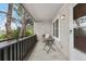 View of the outdoor patio with black railings, a table, and chairs at 7110 S Gaylord St # O7, Centennial, CO 80122