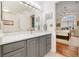 Bathroom vanity area with a decorative mirror, fixtures, and ample countertop space at 18489 E Columbia Cir, Aurora, CO 80013