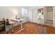 Bright bedroom featuring a functional desk area, hardwood floors and white trim at 18489 E Columbia Cir, Aurora, CO 80013