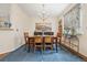 Dining room area featuring neutral walls, elegant chandelier, and a large rectangular dining table at 18489 E Columbia Cir, Aurora, CO 80013