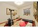Bright exercise room with light and neutral walls, indoor plants and a large framed painting at 18489 E Columbia Cir, Aurora, CO 80013