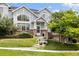 Charming two-story home with red brick accents, well-maintained landscaping, and a bright, welcoming facade at 18489 E Columbia Cir, Aurora, CO 80013