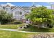 Inviting townhome with mature tree, brick accents, and welcoming front entrance at 18489 E Columbia Cir, Aurora, CO 80013