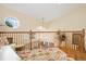 Hallway features a decorative rug, wood railing, and octagonal window at 18489 E Columbia Cir, Aurora, CO 80013