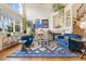 Inviting living room with high ceilings, fireplace, large windows, and stylish blue furniture at 18489 E Columbia Cir, Aurora, CO 80013