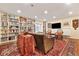 A cozy living room with built-in bookcases and ample space for seating at 18489 E Columbia Cir, Aurora, CO 80013