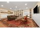 Cozy living room featuring custom built-in bookcases and recessed lighting at 18489 E Columbia Cir, Aurora, CO 80013