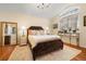 Bright primary bedroom features hardwood floors, chandelier, and decorative rug at 18489 E Columbia Cir, Aurora, CO 80013
