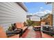 Cozy, stylish patio with comfortable orange-cushioned seating and potted plants at 18489 E Columbia Cir, Aurora, CO 80013