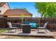 Backyard wooden deck with metal chairs, pillows, and a fire pit for a relaxing outdoor experience at 2390 N Springwood Ct, Lafayette, CO 80026