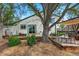 Outdoor patio with seating and mature trees overlooking the landscaped backyard at 2390 N Springwood Ct, Lafayette, CO 80026