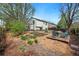 Spacious backyard with a patio, garden beds, fire pit seating, and mature trees for relaxation and entertaining at 2390 N Springwood Ct, Lafayette, CO 80026