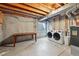 Unfinished basement featuring a laundry area with a washer and dryer and folding table at 2390 N Springwood Ct, Lafayette, CO 80026