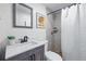 Updated bathroom showcases a modern vanity, a tile shower, and decorative mirror at 2390 N Springwood Ct, Lafayette, CO 80026
