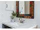 Stylish bathroom featuring a bright vanity with unique mirror and decor at 2390 N Springwood Ct, Lafayette, CO 80026