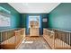 Charming bedroom featuring two cribs, blue accent wall, and bright natural light at 2390 N Springwood Ct, Lafayette, CO 80026