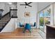 Dining area features hardwood floors, modern lighting, and sliding glass door to the backyard at 2390 N Springwood Ct, Lafayette, CO 80026