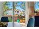 Sunlit kitchen view of the private backyard and patio through sliding glass door at 2390 N Springwood Ct, Lafayette, CO 80026