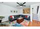 Cozy living room boasts a sectional sofa, a ceiling fan, colorful art, and hardwood floors at 2390 N Springwood Ct, Lafayette, CO 80026