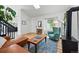 Bright living room with vaulted ceiling, wood floors, statement fireplace, and comfortable turquoise armchair at 2390 N Springwood Ct, Lafayette, CO 80026