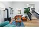 Inviting living room features a cozy sectional, modern fireplace, and bright natural light at 2390 N Springwood Ct, Lafayette, CO 80026