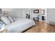 Serene main bedroom with light hardwood floors and ensuite bathroom access at 2390 N Springwood Ct, Lafayette, CO 80026