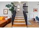 Elegant staircase with dark wood railings, leading to the upper level of the house at 2390 N Springwood Ct, Lafayette, CO 80026