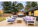 Backyard patio with outdoor seating, hot tub, and mature trees at 3970 Longwood Ave, Boulder, CO 80305