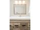 Bathroom vanity featuring wood-look cabinets, long pulls, and a framed mirror at 3970 Longwood Ave, Boulder, CO 80305