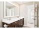Bathroom featuring double sinks, white quartz countertop, and dark wood cabinetry at 3970 Longwood Ave, Boulder, CO 80305